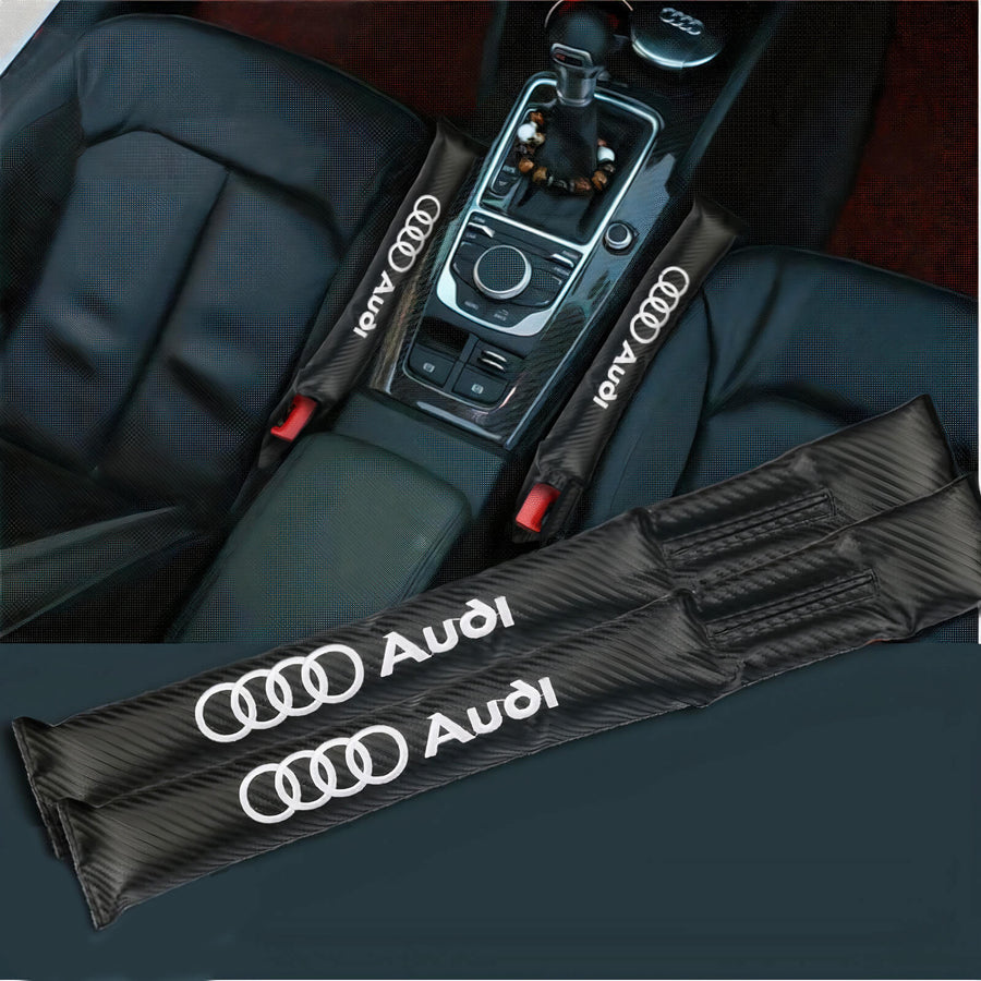 Pair of black Audi seat-gap fillers shown alongside their placement beside a centre console.